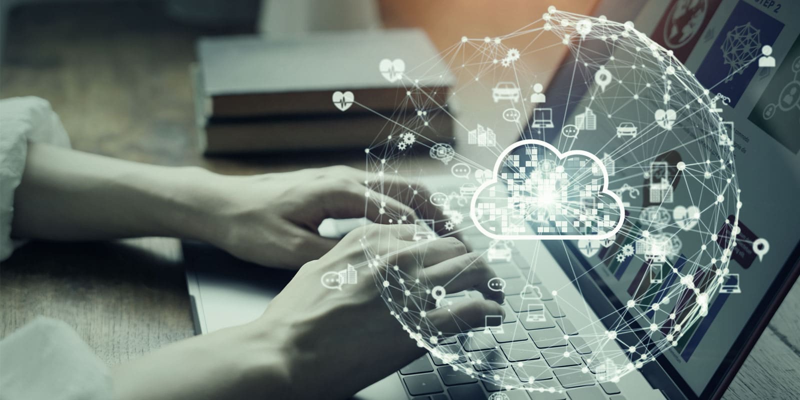 person at laptop with digital representation of the cloud