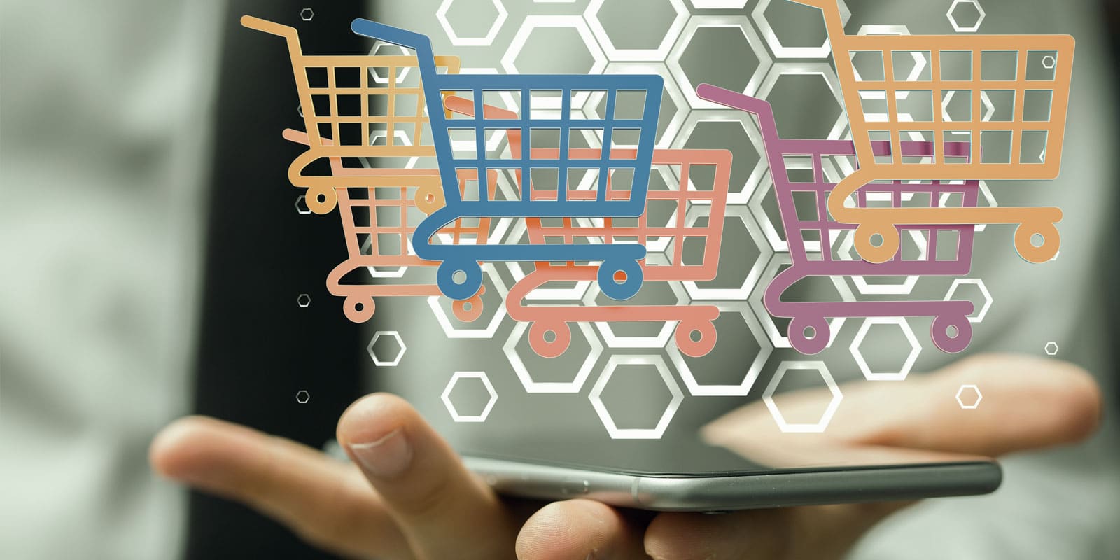 hand holding phone with holographic shopping carts being projected from the screen