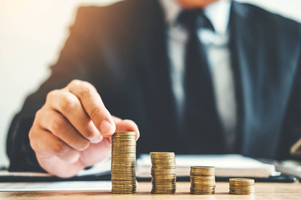 bar graph made of coins with business person
