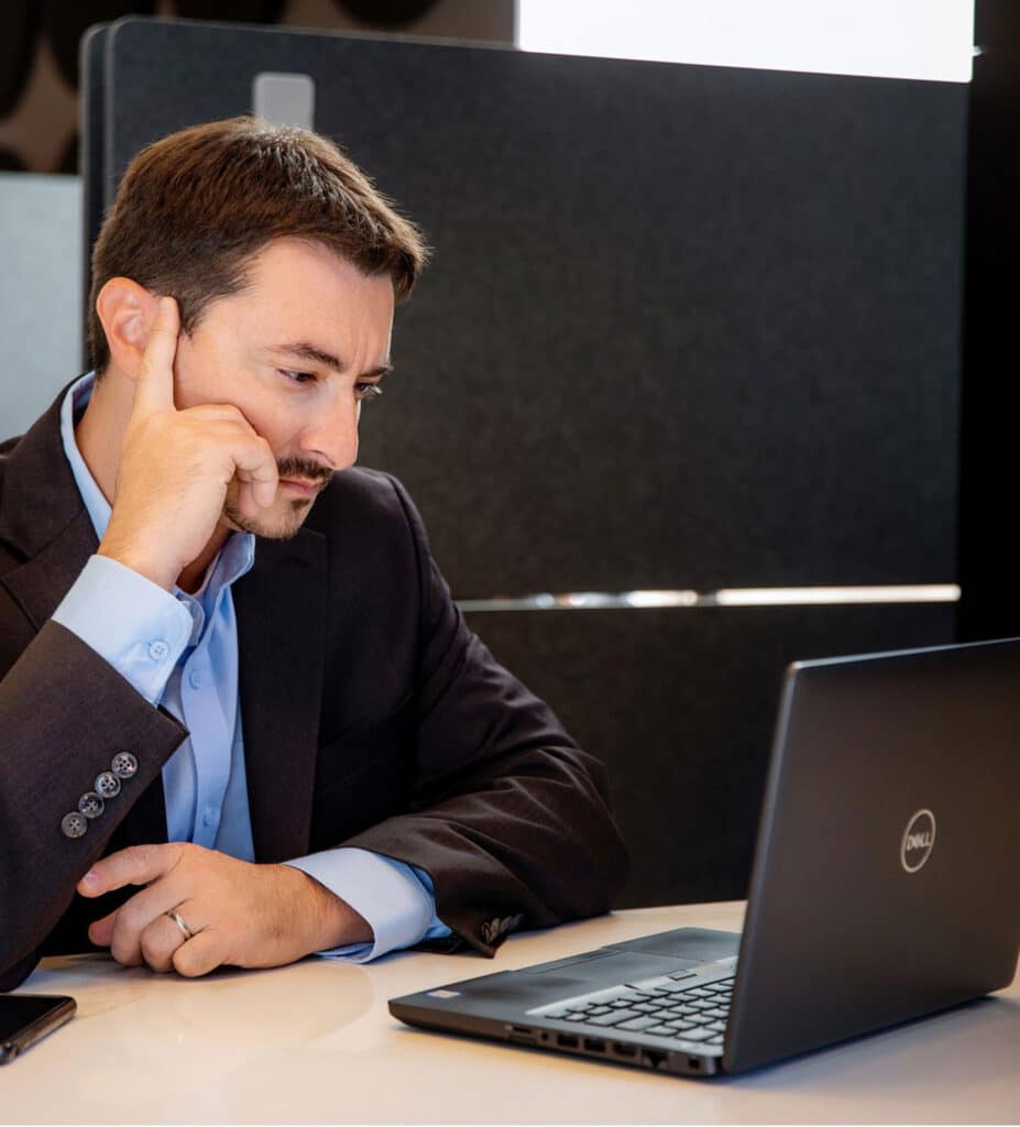Alex Chausovsky Sitting at a Computer